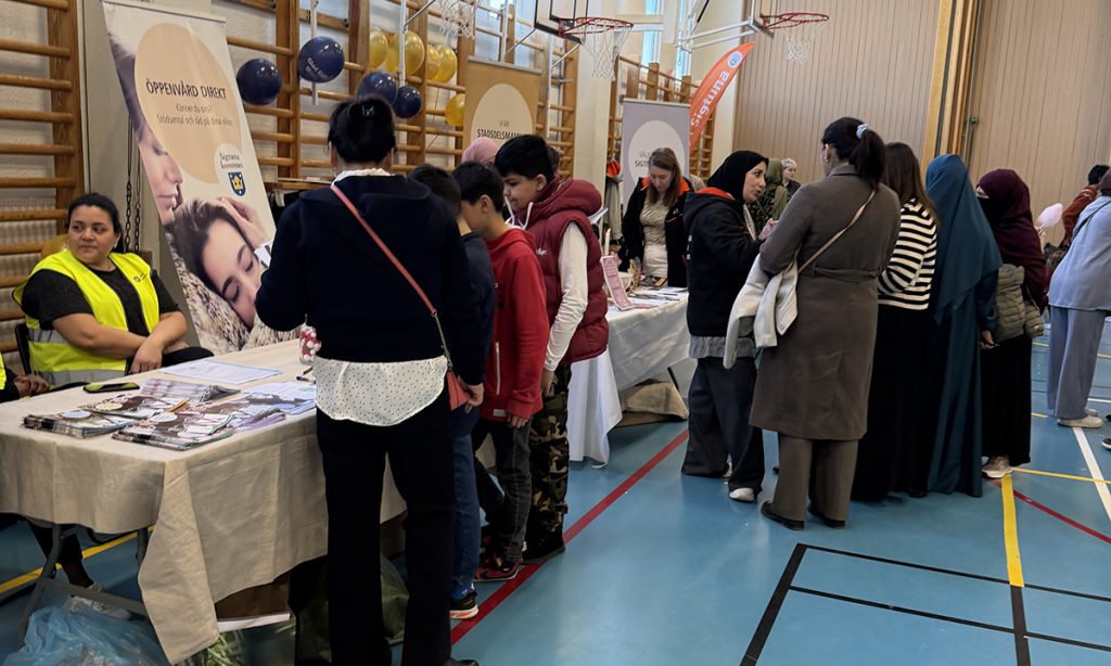 Personer tittar på tryck av samhällsinformation